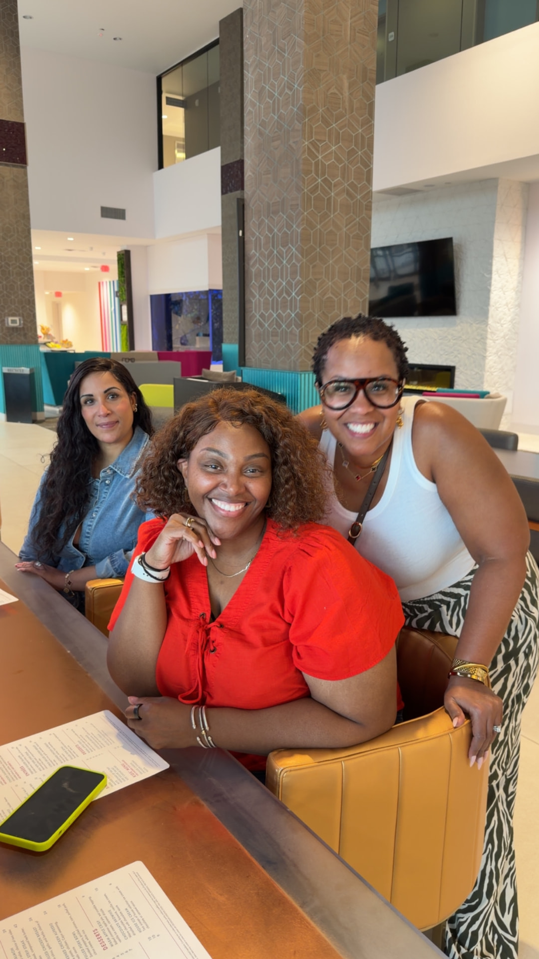 Three Black FRMs Connect community members smiling together at a table during a gathering