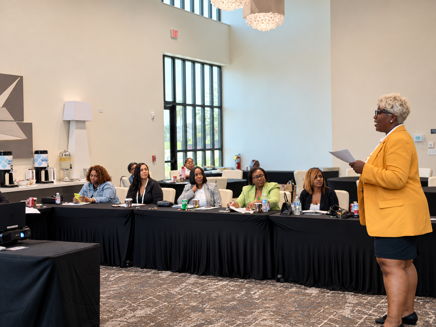 Toya Imani presenting to Black FRMs Connect members seated at the Orlando conference